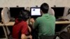FILE - An Iranian man uses a computer at an Internet cafe, in Tehran, May 27, 2013. 