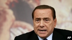 Italian Premier Silvio Berluconi talks to journalists during a press conference at the end of a Cabinet Ministers meeting on the approval of the new austerity measures, in Rome (File Photo - August 12, 2011)