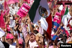 People take part in a protest in support of the National Electoral Institute (INE) and against President Andres Manuel Lopez Obrador's plan to reform the electoral authority, in Mexico City, Mexico, Feb. 26, 2023.