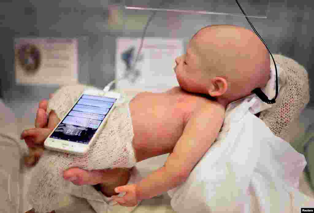 A Babyclon Animatronic baby is displayed at the Bilbao Reborn Doll Show, a trade fair featuring hyperrealist silicone and vinyl babies, known as "Reborns", in Bilbao, northern Spain.