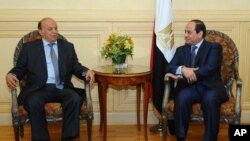 President Abed Rabbo Mansour Hadi, right, meets with Egyptian President Abdel Fattah al-Sissi after his arrival to attend an Arab summit in Sharm el-Sheikh, March 27, 2015.
