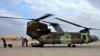 In this Jan. 13, 2020, photo, a U.S. Air Force helicopter sits at Ain al-Asad air base, in Anbar, Iraq. The U.S.-led coalition pulled out from a base in the country's west as part of plans to drawdown on March 19, 2020, amid fears of a viral pandemic. 