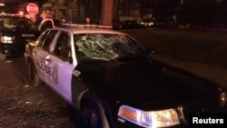 A police car with broken windows is seen in this photograph released by the Milwaukee Police Department after disturbances following the police shooting of a man in Milwaukee, Wisconsin, Aug. 13, 2016.