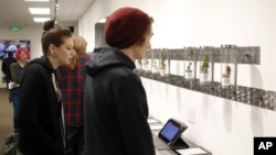 Para konsumen memperhatikan produk yang dipajang di toko Shango Premium Cannabis, di Portland, Oregon, 1 Oktober 2015. 