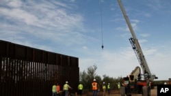 Workers break ground on new border wall construction about 20 miles west of Santa Teresa, New Mexico, Aug. 23, 2019. 