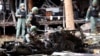 FILE - Thai bomb squad officers examine the wreckage of a car after an explosion outside a hotel in Pattani province, southern Thailand, Aug. 24, 2016.