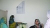 A woman casts her ballot at a polling station during voting to elect lawmakers for legislative assembly in Pakistan-administered Kashmir, in Muzaffarabad, July 25, 2021. 