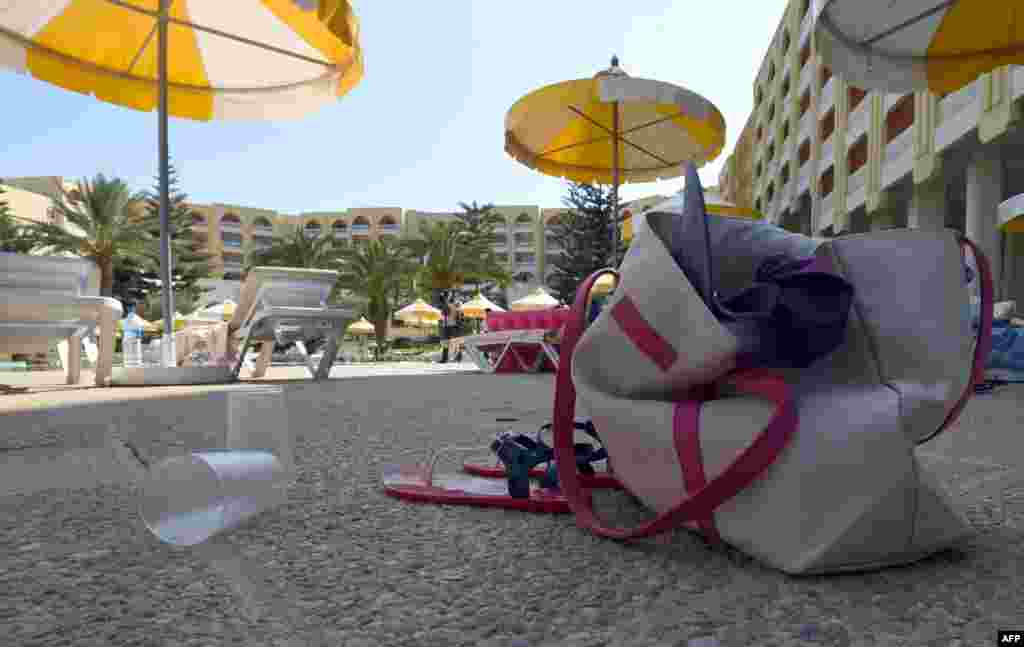 Items belonging to tourists are left behind at the swimming pool at the Thalasso & Spa hotel in the Tunisian resort town of Sousse, following a mass shooting. At least 37 people, including foreigners, were killed at the resort packed with vacationers, in the North African country's worst attack in recent history.