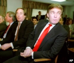 Billionaire developer Donald Trump, right, waits with his brother Robert for the start of a Casino Control Commission meeting in Atlantic City, N.J., March 29, 1990.
