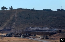 Turkey's tanks and vehicles hold positions close to the border with Syria, Oct. 9, 2017. Turkey's military said Monday that Turkish troops moved into Syria's northwestern Idlib province as part of an operation to enforce an internationally agreed upon de-escalation zone.