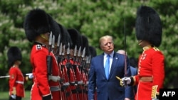 US President Donald Trump inspects an honour guard during a welcome ceremony at Buckingham Palace in central London on June 3, 2019, on the first day of their three-day State Visit to the UK.