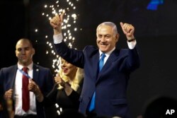 Israel's Prime Minister Benjamin Netanyahu waves to his supporters after polls for Israel's general elections closed in Tel Aviv, Israel, Wednesday, April 10, 2019.