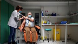 Dr. Christian Chidiac gets a Pfizer-BioNTech COVID-19 vaccine in La Croix-Rousse hospital, in Lyon, central France, Jan. 6, 2021.