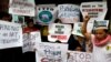 Filipino Muslims display placards during a rally to protest Myanmar's persecution of Rohingya Muslims outside Myanmar's embassy in Makati, Metro Manila, Philippines, Sept. 8, 2017.