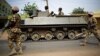 FILE - Nigerian troops patrol in the northeastern Nigeria city of Mubi, 20 kilometers (14 miles) west of the Cameroon border, March 2015.