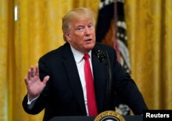 FILE - U.S. President Donald Trump hosts an event honoring those working for Immigration and Customs Enforcement and Customs Border Protection at the White House in Washington, Aug. 20, 2018.