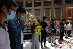Pro-democracy protesters observe a minute of silence during a protest after China's parliament passes a national security law for Hong Kong, in Hong Kong, June 30, 2020.
