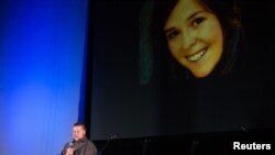 FILE - Eric Mueller reads a poem about his late sister, aid worker Kayla Mueller, at the Prescott's Courthouse Square in Prescott, Arizona, Feb. 18, 2015. 