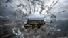 FILE - The city of Mekele is seen through a bullet hole in a stairway window of the Ayder Referral Hospital, in the Tigray region of northern Ethiopia, May 6, 2021. Ethiopian military airstrikes hit the capital of the country's Tigray region Oct. 18, 2021