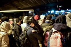 Migrants are gathered before being evacuated by French police in Paris on November 7, 2019. - More than a thousand migrants and homeless have settled camp in this area for months.