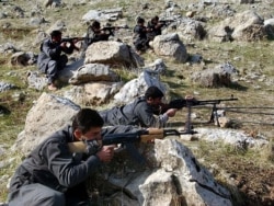 FILE -Recruits of PEJAK, the Party for a Free Life in Kurdistan, a splinter group of the PKK, the Kurdistan Workers Party, take defensive positions near the PEJAK training camp in the Qandil mountain range, northern Iraq.