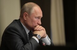 FILE - Russian President Vladimir Putin chairs a meeting at the Novo-Ogaryovo state residence outside Moscow, Russia, Oct. 16, 2019.