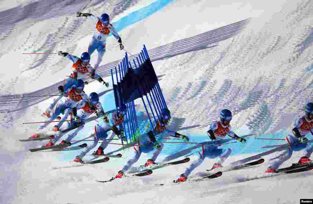 This multiple exposure image shows Austria's Benjamin Raich clearing a gate during the second run of the men's alpine skiing giant slalom event, Rosa Khutor Alpine Center, Feb. 19, 2014.