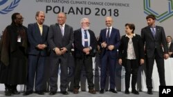Heads of the delegations react at the end of the final session of the COP24 summit on climate change in Katowice, Poland, Dec. 15, 2018.