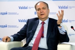 FILE - Anatoly Antonov, Russian ambassador to the U.S. gestures while speaking during a round-table discussion on the Trump-Putin summit in Helsinki in Moscow, July 20, 2018.
