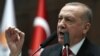FILE - President of Turkey and leader of Justice and Development (AK) Party Recep Tayyip Erdogan speaks at the party's group meeting at Grand National Assembly of Turkey in Ankara, Feb. 12, 2020.