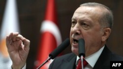 FILE - President of Turkey and leader of Justice and Development (AK) Party Recep Tayyip Erdogan speaks at the party's group meeting at Grand National Assembly of Turkey in Ankara, Feb. 12, 2020.