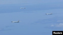 A Russian TU-95 bomber and Chinese H-6 bombers fly over East China Sea in this handout picture