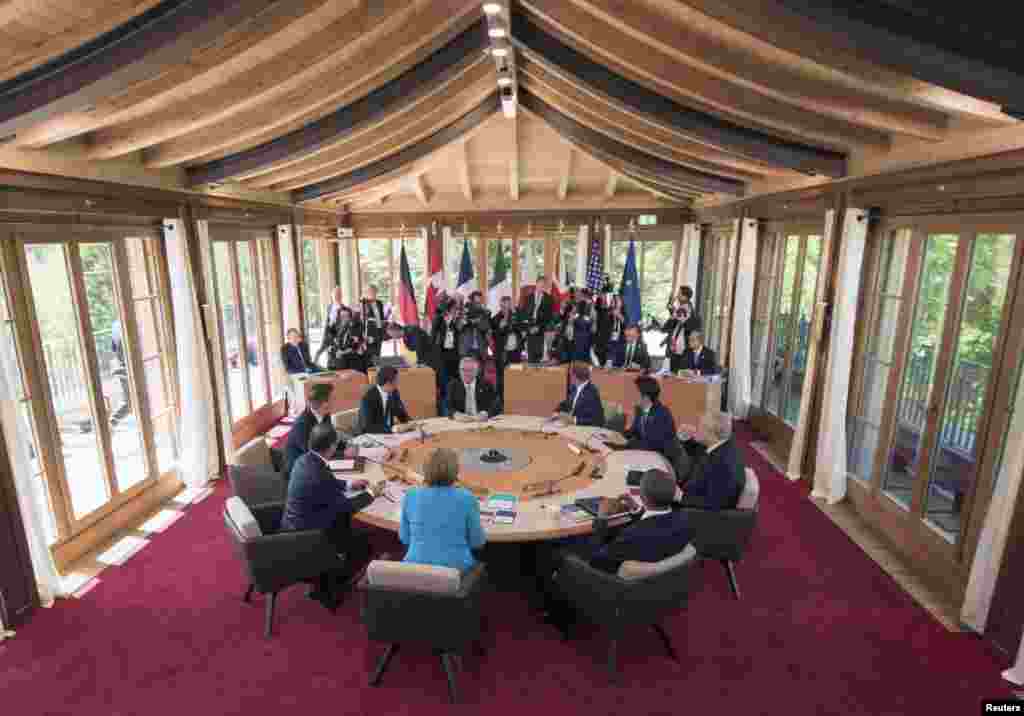 French President Francois Hollande, British Prime Minister David Cameron, Italy's Prime Minister Matteo Renzi, Germany's Chancellor Angela Merkel, European Union Commission President Jean-Claude Juncker, President of the European Council Donald Tusk, Japanese Prime Minister Shinzo Abe, U.S. President Barack Obama and Canada's Prime Minister Stephen Harper attend the first working session of a G7 summit at the hotel castle Elmau in Kruen, Germany, June 7, 2015.