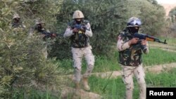 FILE - Egyptian Army officers are seen in the troubled northern part of the Sinai Peninsula during a launch of a major assault against militants, in Al Arish, Egypt, in this undated handout picture made available by the Ministry of Defense, March 4, 2018.