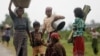 Rohingya Muslims carry their belongings as they move after recent violence in Sittwe, Burma, June 16, 2012. 