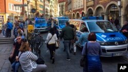 Police vans stand in downtown Muenster, Germany, April 7, 2018, after a motorist's attack on a crowd.