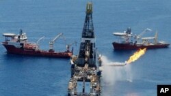 The Transocean Discoverer Enterprise drillship burns off gas collected at the BP Deepwater Horizon oil spill in the Gulf of Mexico off the coast of Louisiana, 25 June 2010