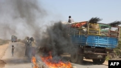 A truck passing a partial roadblock setup by residents as a protest against the Islamist Al-Shabab insurgent group, in Tobanka Buundo in the lower Shabelle region, near the Somalian capital Mogadishu, March 6, 2014.
