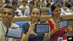 Students in in New Delhi, India, display Aakash, which means "sky" in Hindi. It is called the world's cheapest tablet computer. (2011 FILE PHOTO)