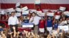 Republican presidential candidate Mitt Romney (L) smiles as he listens to his vice presidential running mate Representative Paul Ryan, R-Wisconsin, speak at a rally in Mooresville, North Carolina, August 12, 2012.