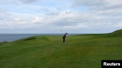 A golfer plays a shot on the Golfklubberinn Oddur golf course in Rekyavik June 5, 2013. About 10 percent of Iceland's population plays golf - a higher rate than the United States or Britain - making it the country's second most popular sport, after soccer.