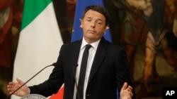 Italian Prime Minister Matteo Renzi speaks during a press conference at the premier's office Chigi Palace in Rome, early Monday, Dec. 5, 2016. Renzi acknowledged defeat in a constitutional referendum and announced he would resign on Monday. 