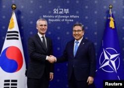 NATO Secretary General Stoltenberg shakes hands with South Korean Foreign Minister Park Jin during their meeting at the Foreign Ministry, in Seoul