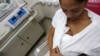 FILE - A mother performs Kangaroo care, or skin-to-skin contact, with her premature baby to give the baby the physical stimulation it needs.