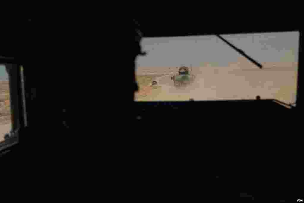 Soldiers belonging to the Kurdish-led military patrol the vicinity of Al-Hol camp, near the border area between Syria and Iraq, on Oct. 12, 2024. (Yan Boechat/VOA)