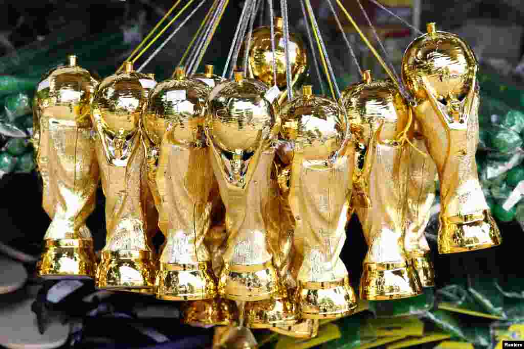 Souvenirs of the World Cup soccer trophy are put on sale in a shop in Ribeirao Preto, 336 km northwest of Sao Paulo, June 13, 2014. 