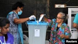 A person votes at a polling station during the Fijian general election in Suva, Fiji, Dec. 14, 2022. 