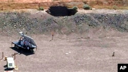 This image provided by the U.S. Department of Energy shows a 20-foot by 20-foot hole in the roof of a storage tunnel at the Hanford Nuclear Reservation near Richland, Washington, May 9, 2017. 