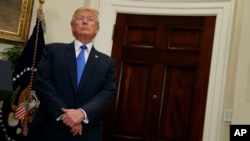 FILE - President Donald Trump listens in the Roosevelt Room of the White House in Washington, Aug. 2, 2017.