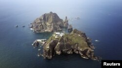 A set of remote islands called Dokdo in Korean and Takeshima in Japanese is seen in this picture taken from a helicopter, Aug. 10, 2012.